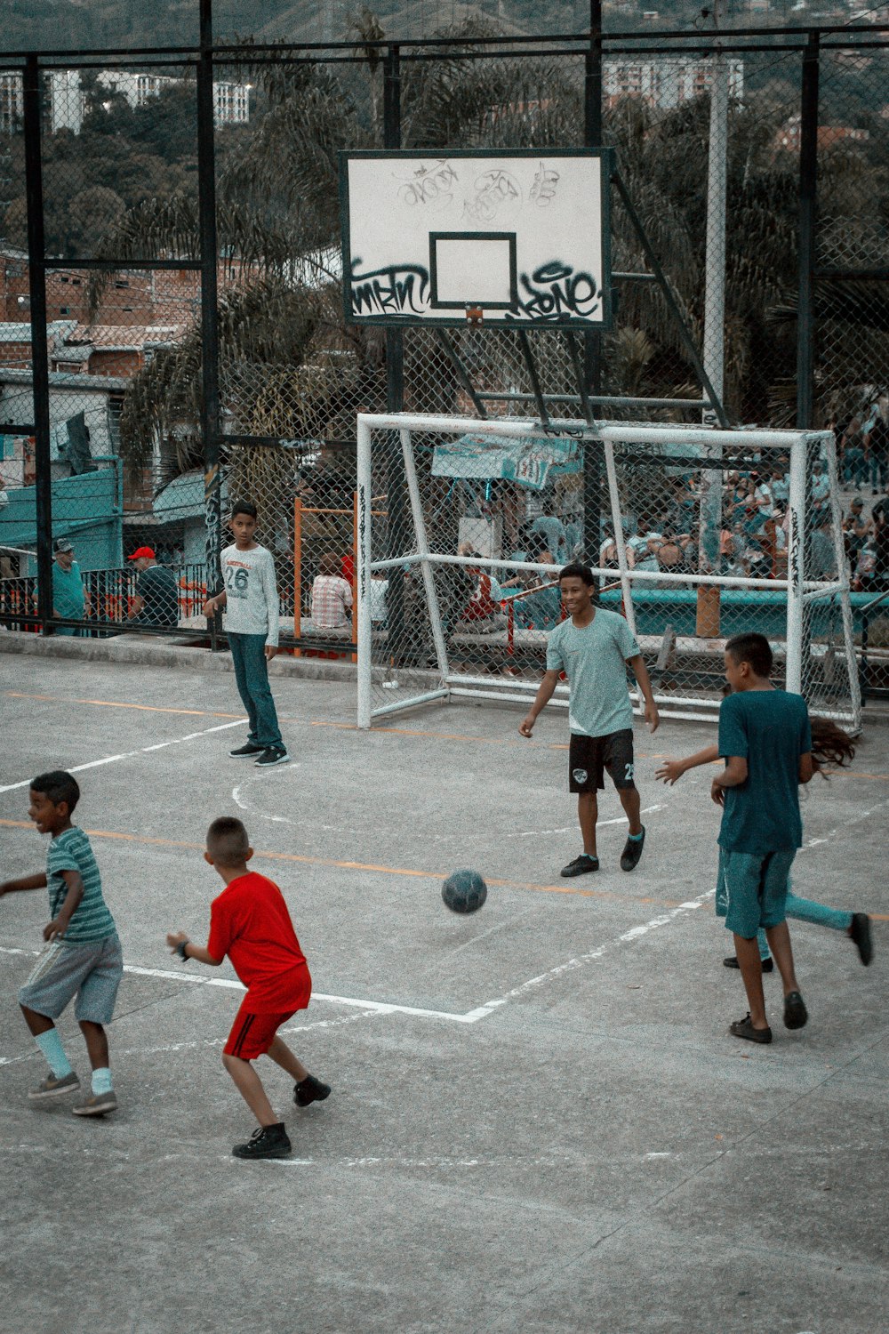 group of people playing basketball during daytime