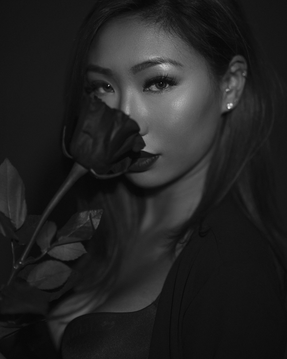grayscale photo of woman holding rose
