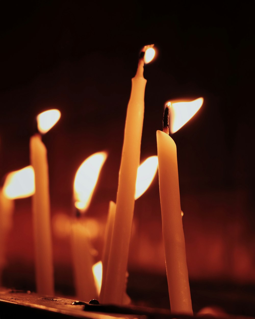 white candles on black background