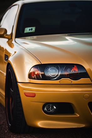 brown car with black and white car in the distance