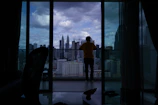 City skyline view from a high-rise apartment balcony.