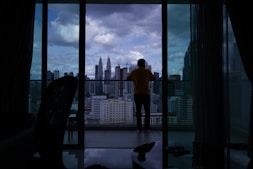 City skyline view from a high-rise apartment balcony.