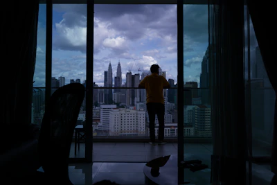 City skyline view from a high-rise apartment balcony.