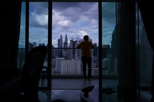 Balcony view overlooking Dubai skyline from a high-rise apartment.