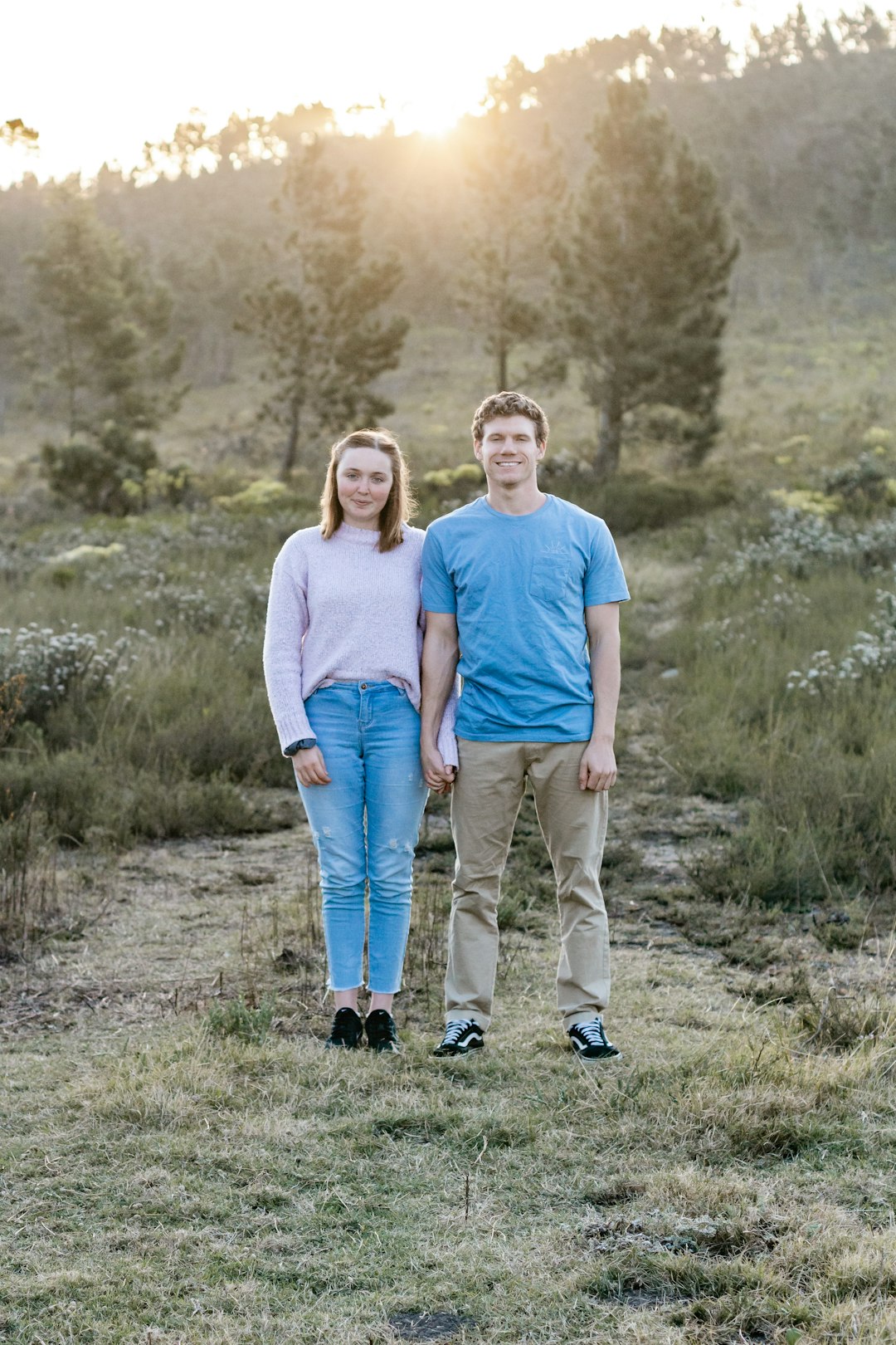 man in blue crew neck t-shirt standing beside woman in white t-shirt