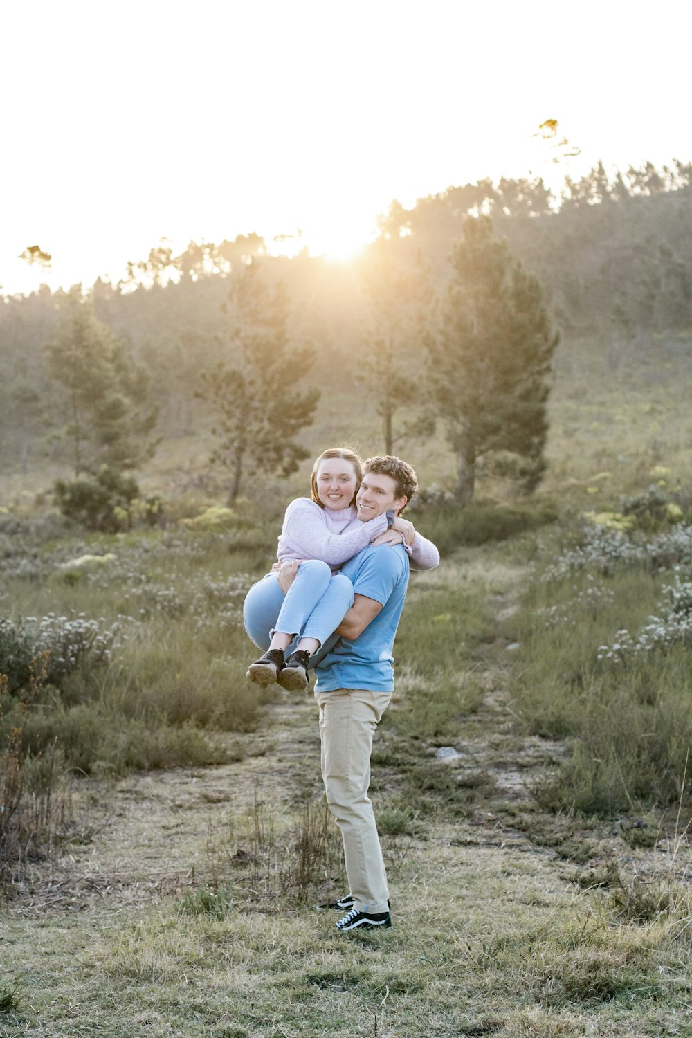 woman in blue long sleeve shirt carrying baby in blue shirt