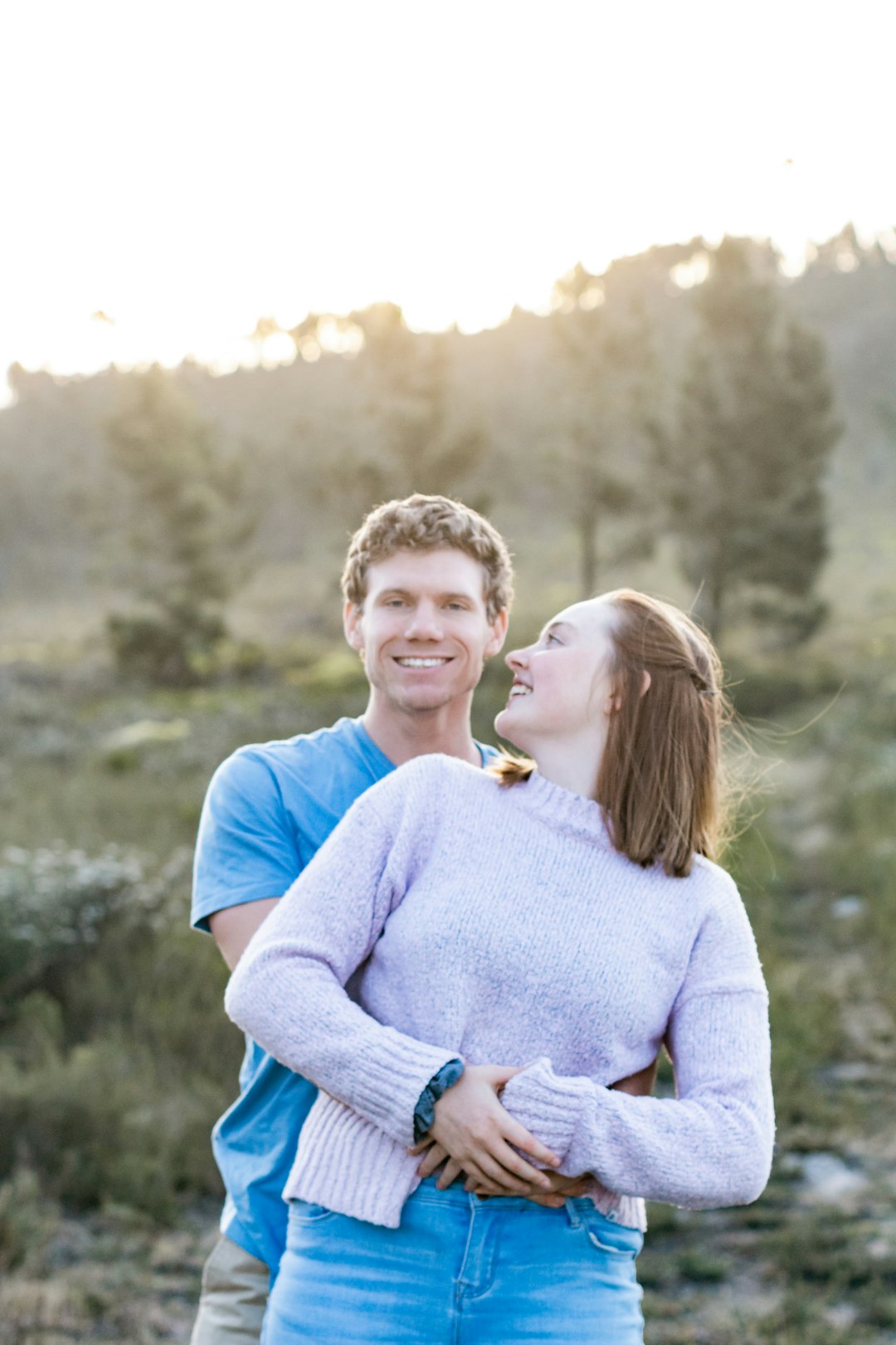 woman in blue sweater hugging woman in white sweater