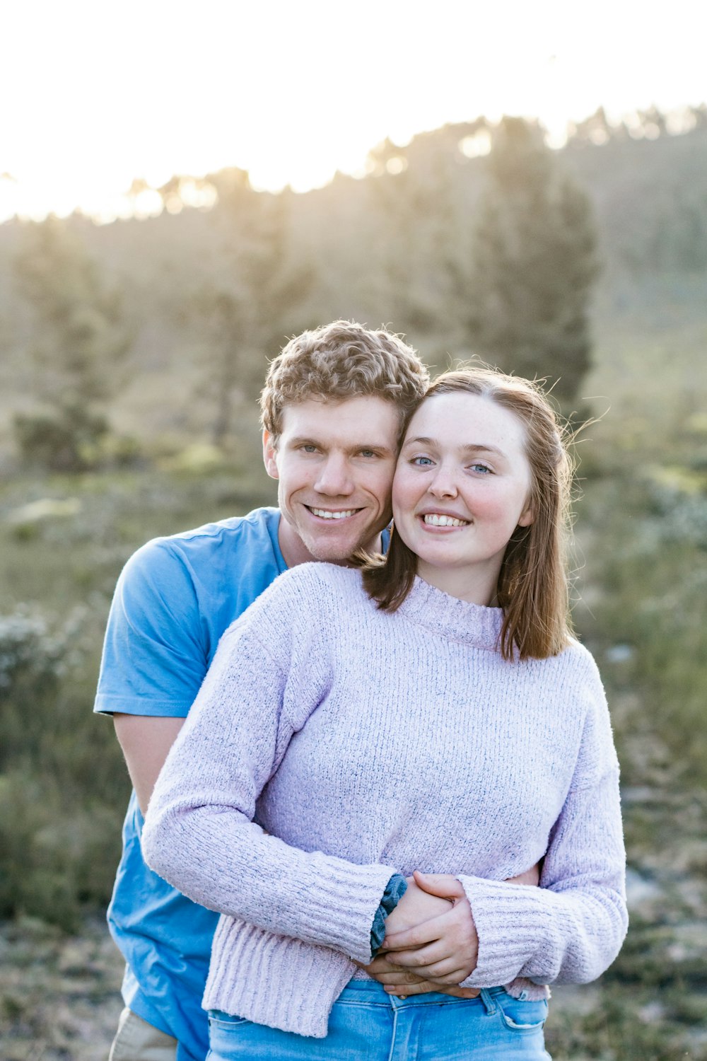 man in blue crew neck t-shirt beside woman in gray sweater