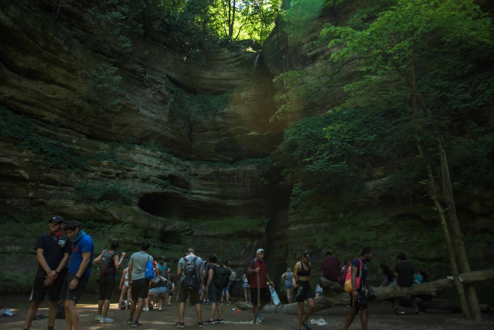 people walking on pathway between rocks during daytime