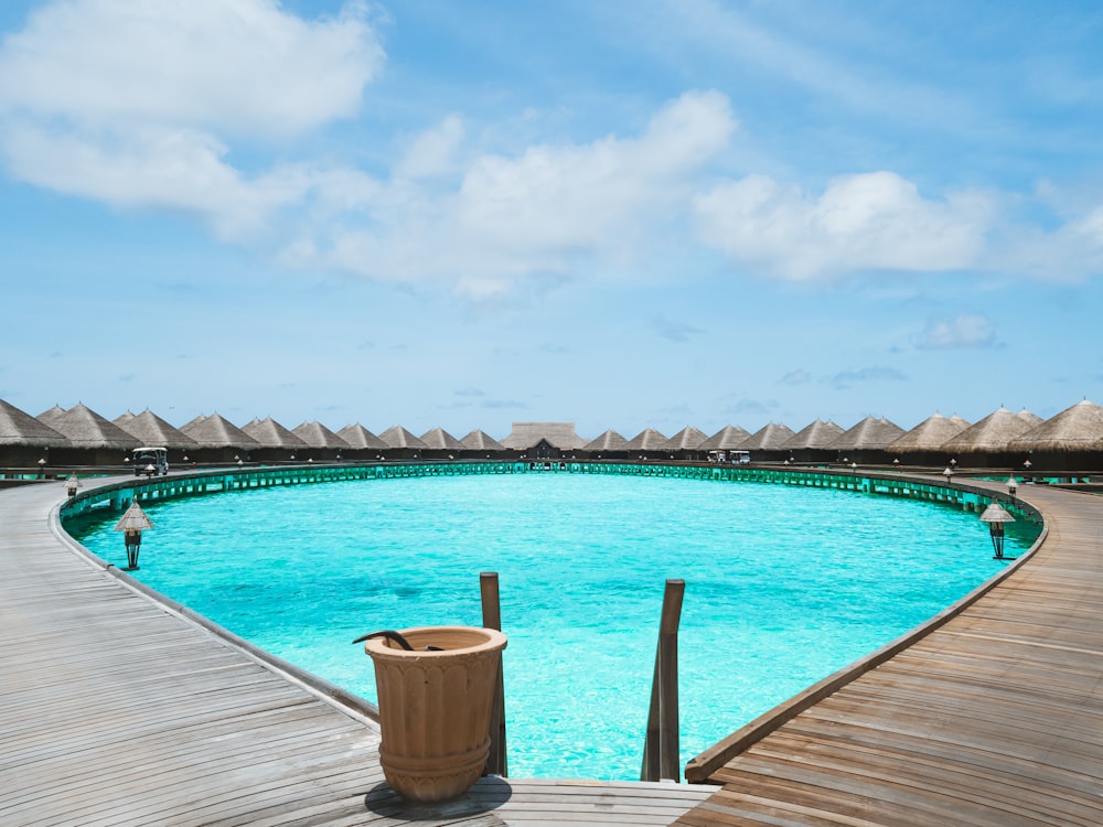 brown wooden dock on blue body of water under blue sky during daytime