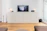 A modern living room featuring a sleek modular cabinet from Aroeira Decor.