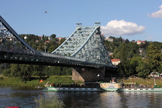 white boat on water under bridge during daytime in Blaues Wunder Germany