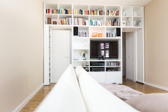 black flat screen tv on white wooden tv rack