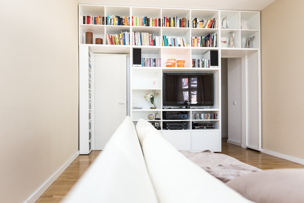 black flat screen tv on white wooden tv rack