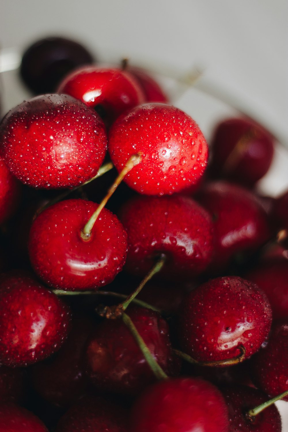 red cherry fruit in white ceramic bowl