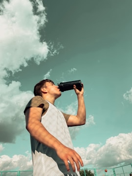 Person enjoying a refreshing drink outdoors with Lift Detox Black