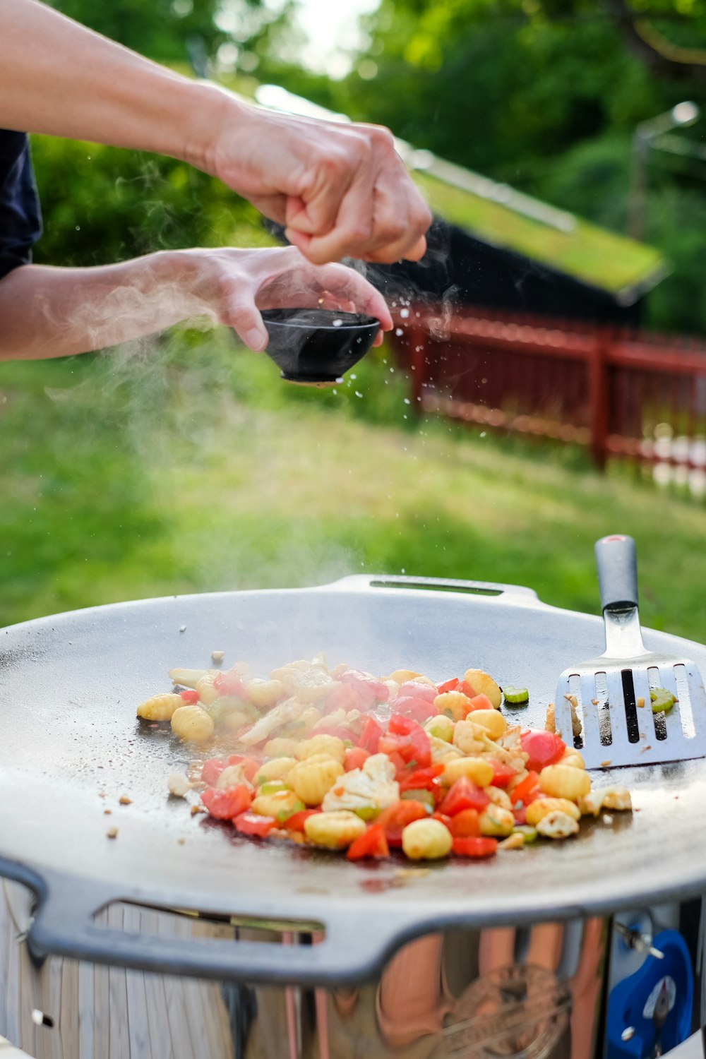 person holding stainless steel fork and knife slicing vegetable