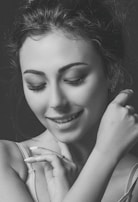 A close-up of a woman smiling softly, radiating newfound strength and calm.