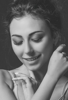 A serene image of a woman smiling, symbolizing confidence and self-acceptance.