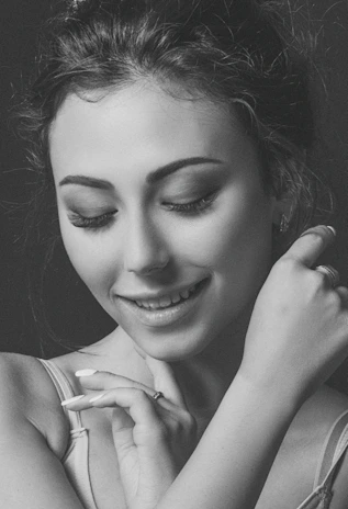 Close-up of a confident woman smiling softly, embodying self-discovery and empowerment.
