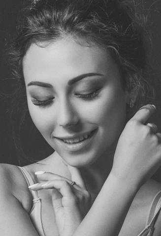 Close-up of a confident woman in her 50s smiling gently, embodying empowerment and calm.