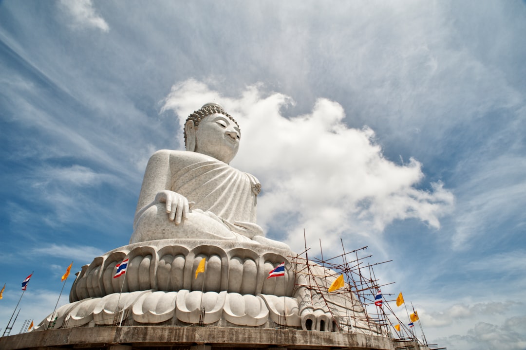 white concrete statue under white clouds during daytime,