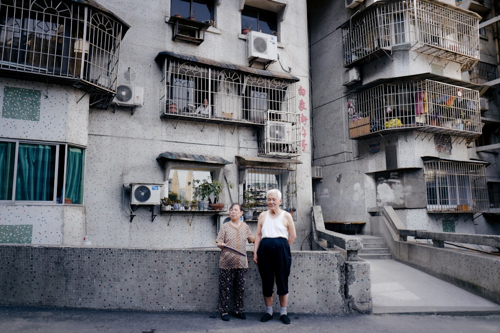 woman in white long sleeve shirt and blue skirt standing on gray concrete stairs