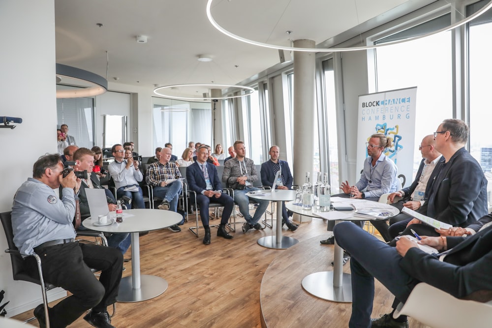 people sitting on chair in conference room