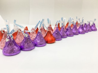 Assorted chocolates wrapped in vibrant foil arranged neatly on a vintage tray.