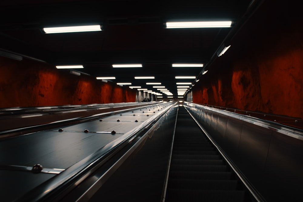 black and white escalator in tunnel