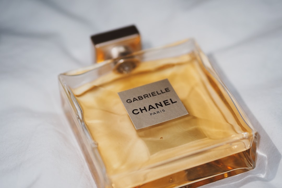love you perfume bottle on white textile,