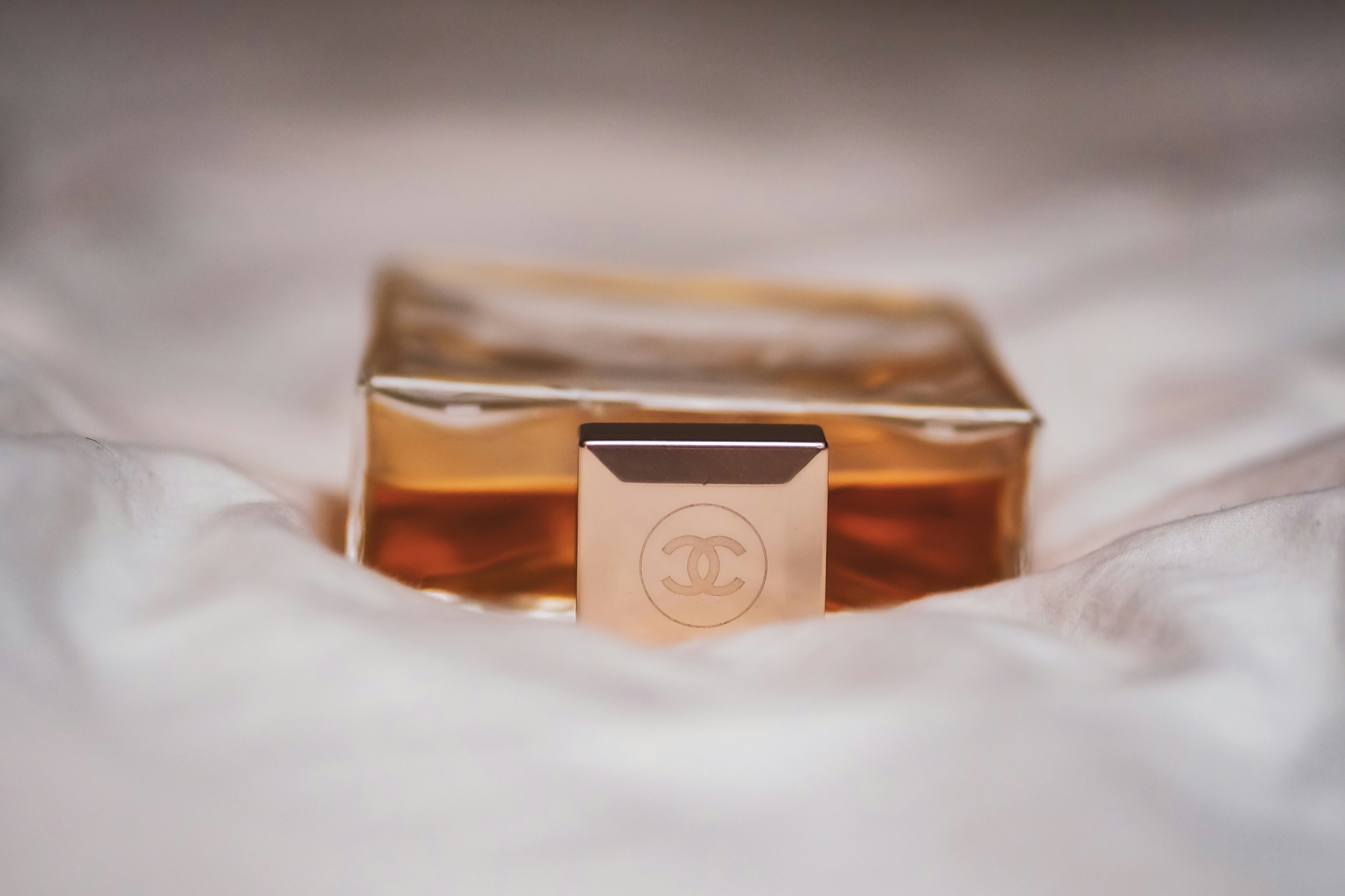 Editorial perfume arrangement on a beige background