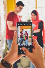 person holding black android smartphone