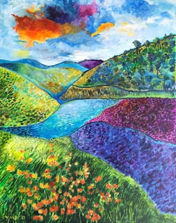A vibrant and colorful landscape painting depicting rolling hills and a small lake. The foreground is filled with bright orange and yellow flowers set against vivid green grass. The hills are in shades of blue, green, and purple, adding depth to the scene. Above, a dramatic sky features a fiery cloud with hues of orange, yellow, and blue.