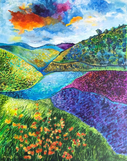 A vibrant and colorful landscape painting depicting rolling hills and a small lake. The foreground is filled with bright orange and yellow flowers set against vivid green grass. The hills are in shades of blue, green, and purple, adding depth to the scene. Above, a dramatic sky features a fiery cloud with hues of orange, yellow, and blue.