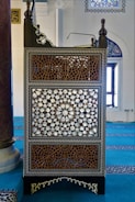 A beautifully carved traditional Jepara mosque pulpit with gold accents.