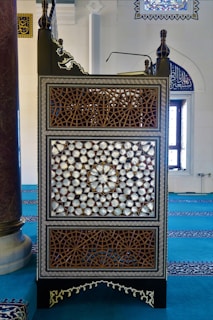 Close-up of intricate wood carvings on a classic golden mosque pulpit.