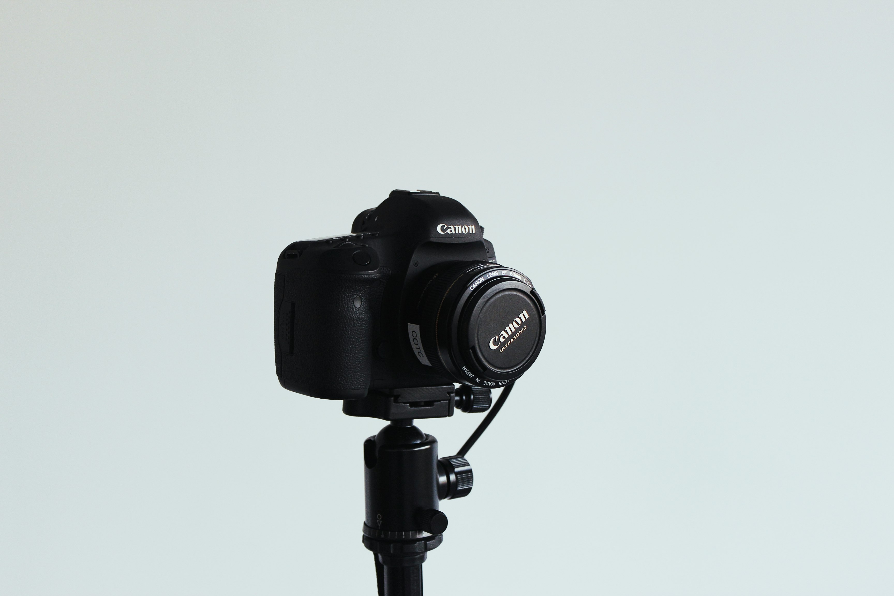 black canon dslr camera on white background