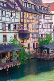 brown and white concrete building beside river during daytime