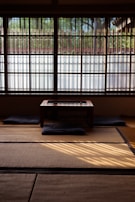 A neatly arranged futon bed on tatami flooring, inviting restful sleep in a traditional setting.