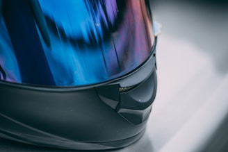 A close-up of a metallic red motorcycle helmet with stylish graphics.