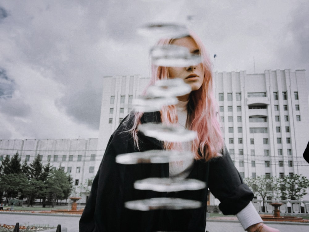 woman in black long sleeve shirt holding clear glass cup