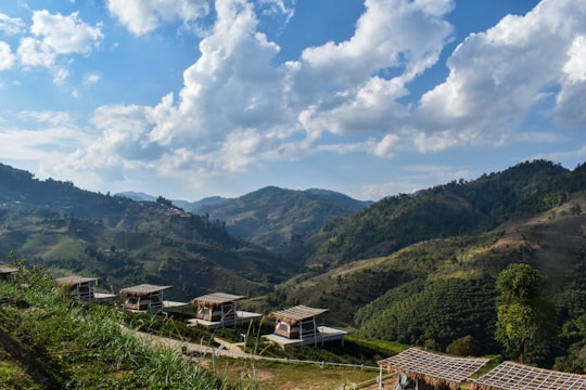 green mountains under white clouds and blue sky during daytime in Chiang Mai Thailand