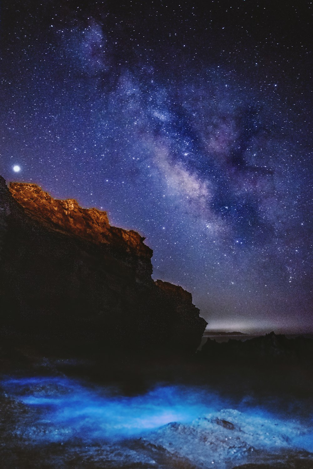 brown rock formation under blue sky during night time