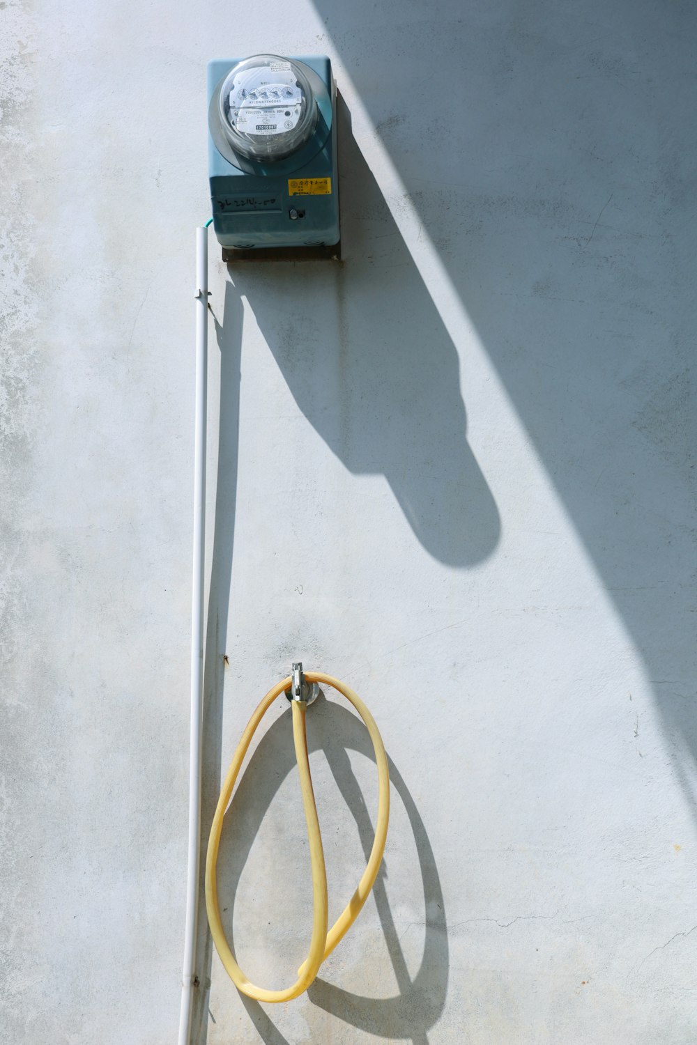 yellow and black electric device mounted on white wall