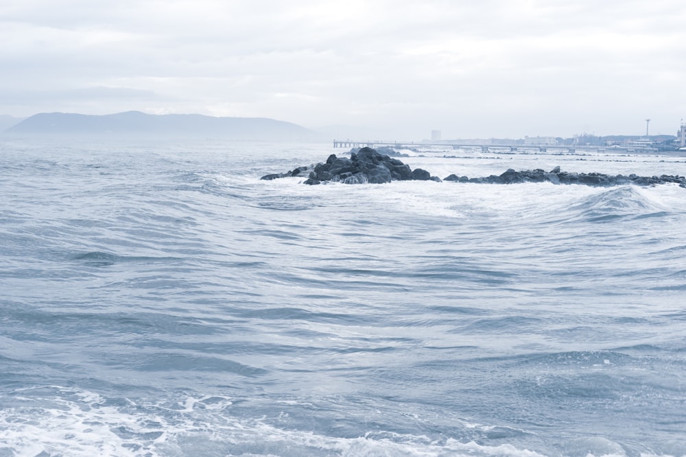 ocean waves crashing on shore during daytime