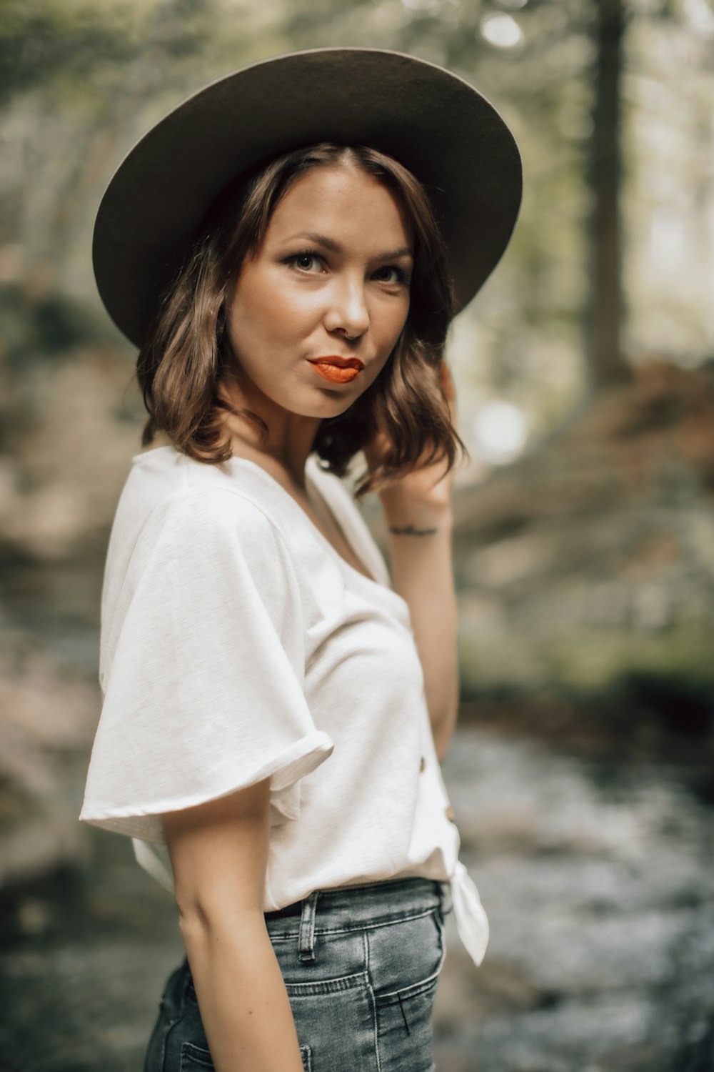 woman in white long sleeve shirt wearing black hat