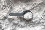 black magnifying glass on white and brown marble table