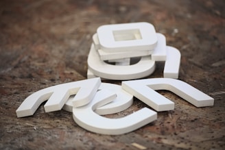 Close-up of custom-made letters arranged neatly on a workshop table.