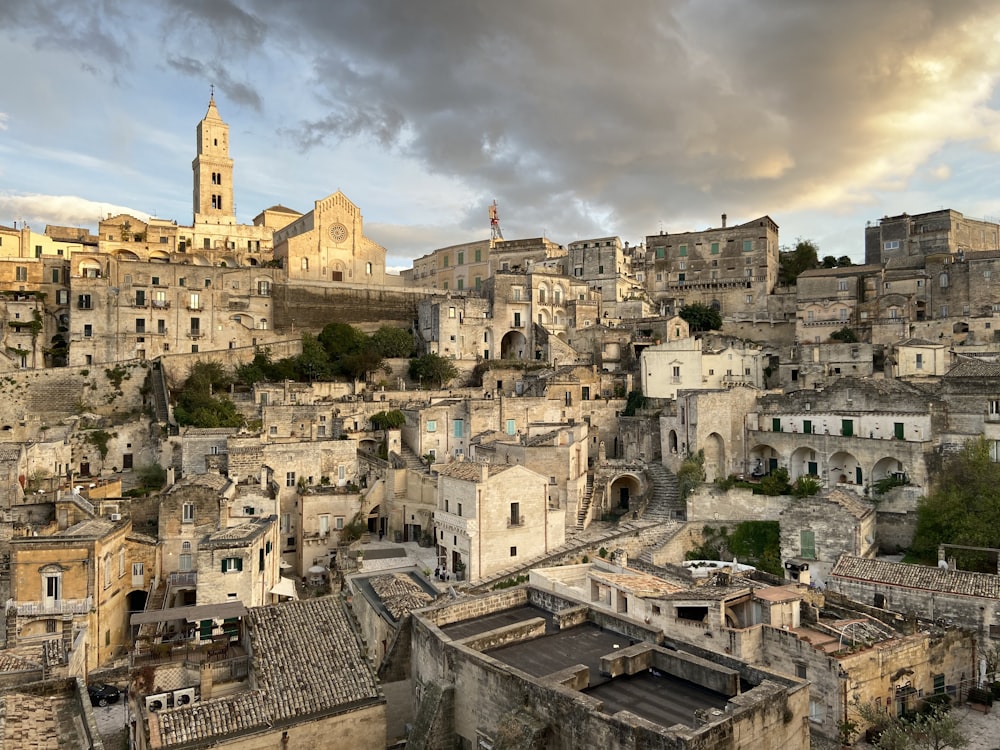 white and brown concrete buildings under white clouds during daytime